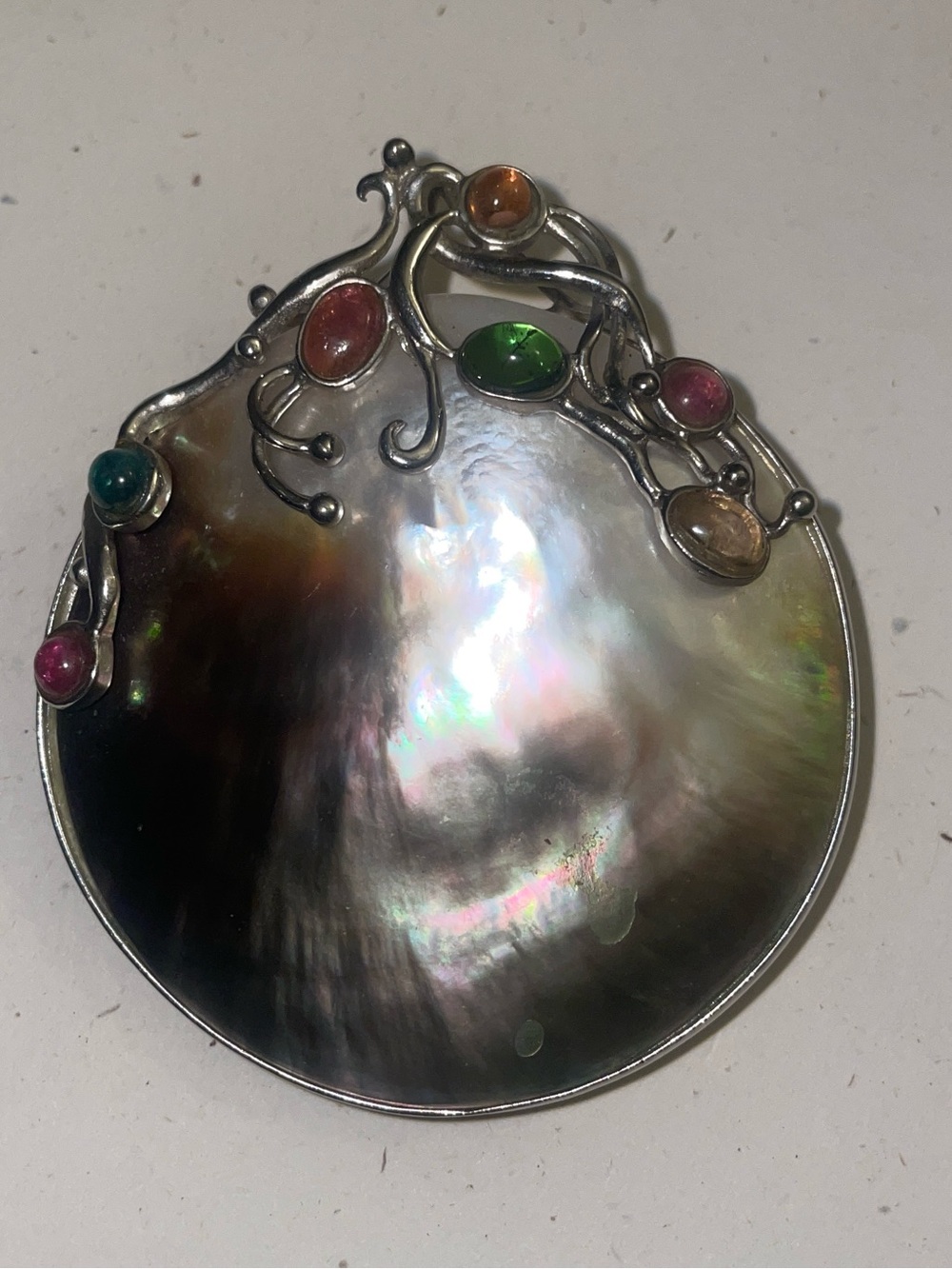 Vintage handcrafted Mother of Pearl shell
With tourmaline gems.
Damaged corner